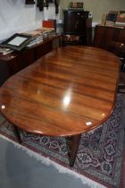 A 1960s Danish rosewood extending dining table with three extra leaves, on tapering supports, 105"