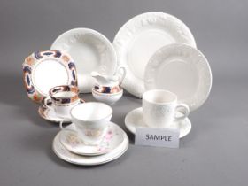 A bone china floral decorated teaset, a white relief decorated part dinner service and an