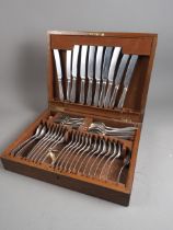 An oak canteen of silver plated cutlery (two knives missing)