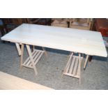 A modern laminate top adjustable height table, on trestle supports, 54" wide x 24" deep x 32" high