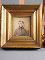 An early 19th century portrait miniature of a gentleman in a brown coat, 3 1/2" x 3", in gilt frame