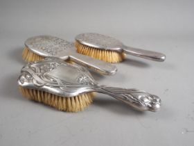 An Arts & Crafts style silver backed hair brush, by Liberty & Co, a matching hair brush, by W H