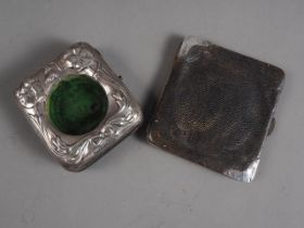 An Art Nouveau silver mounted pocket watch case and a leather purse with silver corners