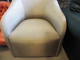 A modern tub shape armchair, upholstered in a grey "silk"