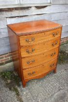 A late 19th century mahogany bowfront chest of four long graduated drawers with bail handles, on