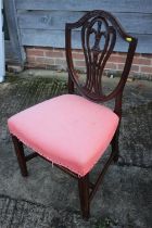 A late Georgian carved mahogany side chair of Hepplewhite design with stuffed over seat, on