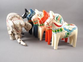 Five Swedish painted wood model horses and a carved and painted wood heffalump string puppet