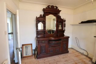 A late Victorian carved mahogany break bowfront dresser with triple plate mirror back, fitted