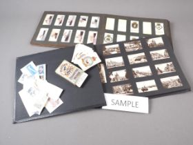 An album of cigarette cards, a Players Navy Cut packet with loose cigarette cards, a photo album and
