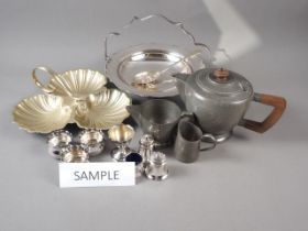 A silver plated four-trumpet epergne, two plated cake baskets, a plated cruet, etc