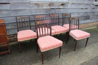 A set of six Regency style mahogany and line inlaid standard dining chairs with padded seats,