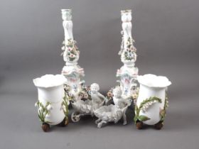 A pair of 19th century Continental porcelain relief decorated candlesticks, 14" high (damages), a