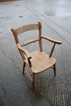 An Oxford bar back elbow chair with elm seat, on turned supports