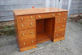 An Edwardian mahogany double pedestal desk, fitted nine drawers and central kneehole, on block base,