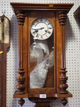 A late 19th century walnut cased wall clock with compensating pendulum, eight-day striking