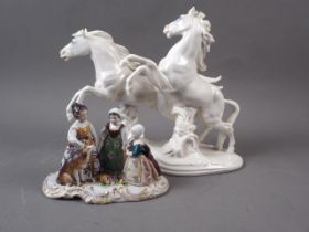 A Karl Ens porcelain model of two galloping horses, 10" high, and a porcelain figure group of the