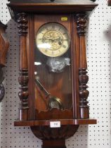 A figured walnut cased Junghans wall clock with compensating pendulum, 29" high