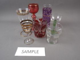 A red and clear glass beaker with panelled decoration, 4" high, another similar glass vase,