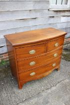 A 19th century mahogany bowfront chest of two short and two long drawers with stamped brass handles,