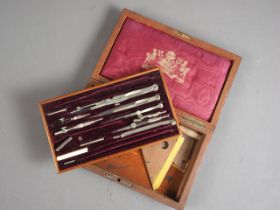 An early 20th century brass bound rosewood box, containing a selection of drawing instruments