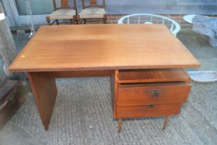 A 1960s teak single pedestal desk, fitted two drawers, 43" wide x 27 1/2" deep x 28 3/4" high