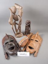Four African carved figure groups, two carved masks and a number of other African carvings