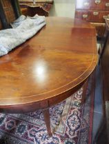 An early 19th century mahogany and line inlaid D-end dining table with extra leaf, on square taper