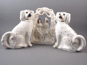 A pair of Staffordshire dogs, 12" high, (one with glass eye missing) and another Staffordshire flat