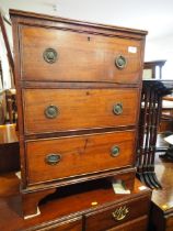 A 19th century walnut, rosewood banded and box strung bedside chest of three drawers with brass ring