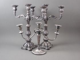 A pair of silver plated three-light candlesticks of Rococo design, 17" high, and a smaller