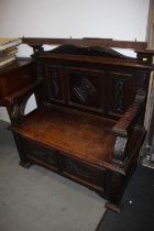 A late 19th century carved oak box seat settle with triple panel back, 41 1/2" wide x 19" deep x 41"