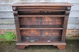 A late Victorian carved oak open bookcase, fitted two shelves, on bracket feet, 46" wide x 13"