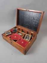A 19th century marquetry workbox with fitted interior containing a selection of coins, cameos,