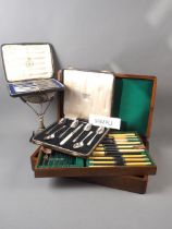 A selection of silver plate comprising two canteens of cutlery, three boxed sets of cutlery,