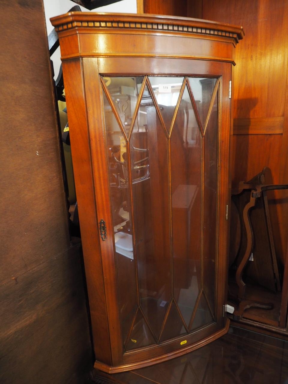 A mahogany low-front corner display cabinet, enclosed lattice glazed door, 26" wide x 16" deep x 73"