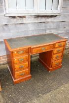 A late 19th century walnut breakfront double pedestal desk with tooled leather line top, fitted