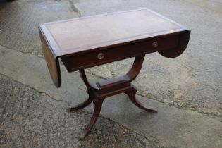 A mahogany sofa table with tooled lined top and leaves, fitted two drawers, on "U" shape support and