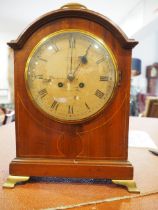 A mahogany and line inlaid arch top bracket clock with cream painted dial and roman numerals, signed