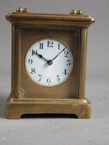 A carriage clock with gilt brass case, 4" high