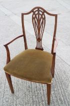 An Edwardian carver chair with pierced splat back and stuffed over seat, on square taper supports