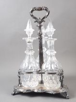 A Victorian silver plated three-decanter tantalus with contemporary decanters, 15 1/2" high (one