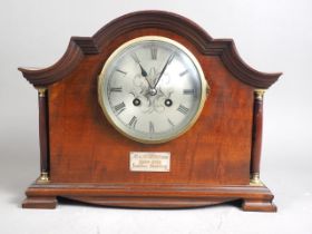 An early 20th century mahogany cased mantel clock with silvered dial and eight-day striking