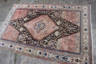 A Qashqai rug with animals in a central medallion and multi-borders in shades of brown, red, blue,