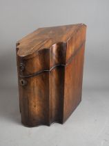 A Georgian mahogany and inlaid serpentine fronted knife box (lacking interior)