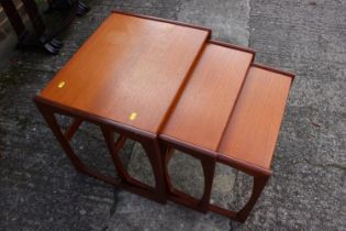 A nest of three "G-Plan" occasional tables, on shaped supports, 21" wide x 17" deep x 19" high