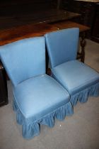 A pair of 1950s low seat occasional chairs, upholstered in a blue fabric