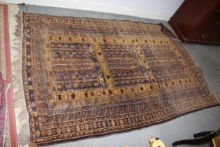 A Kazak style rug with geometric designs in shades of yellow, natural, orange and brown, 57" x 80"