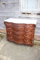 A 19th century American figured walnut marble top serpentine front chest of four long drawers with