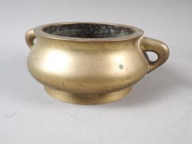 A Chinese bronze two-handled censer, 5 1/2" dia at the top, four-character mark to base