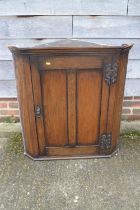 An oak corner hanging cupboard enclosed panel door, 32" wide x 19" deep x 34 1/2" high